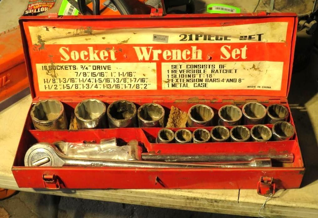 Red, open socket wrench set with sockets and handle in a metal case.