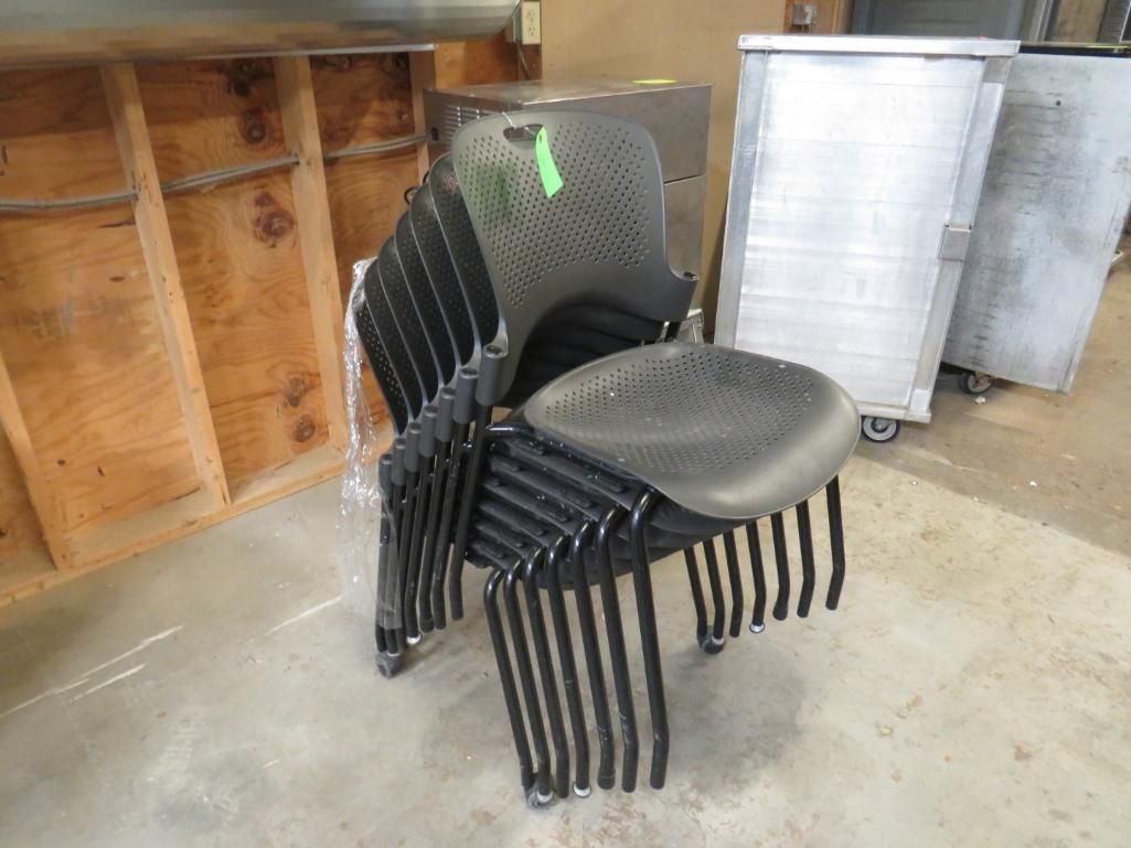 Stack of black chairs.