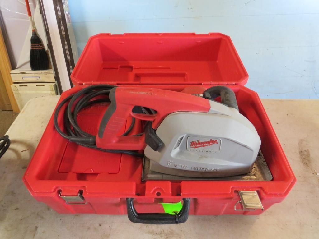 Red tool case open, showing red power sander with black cord inside.