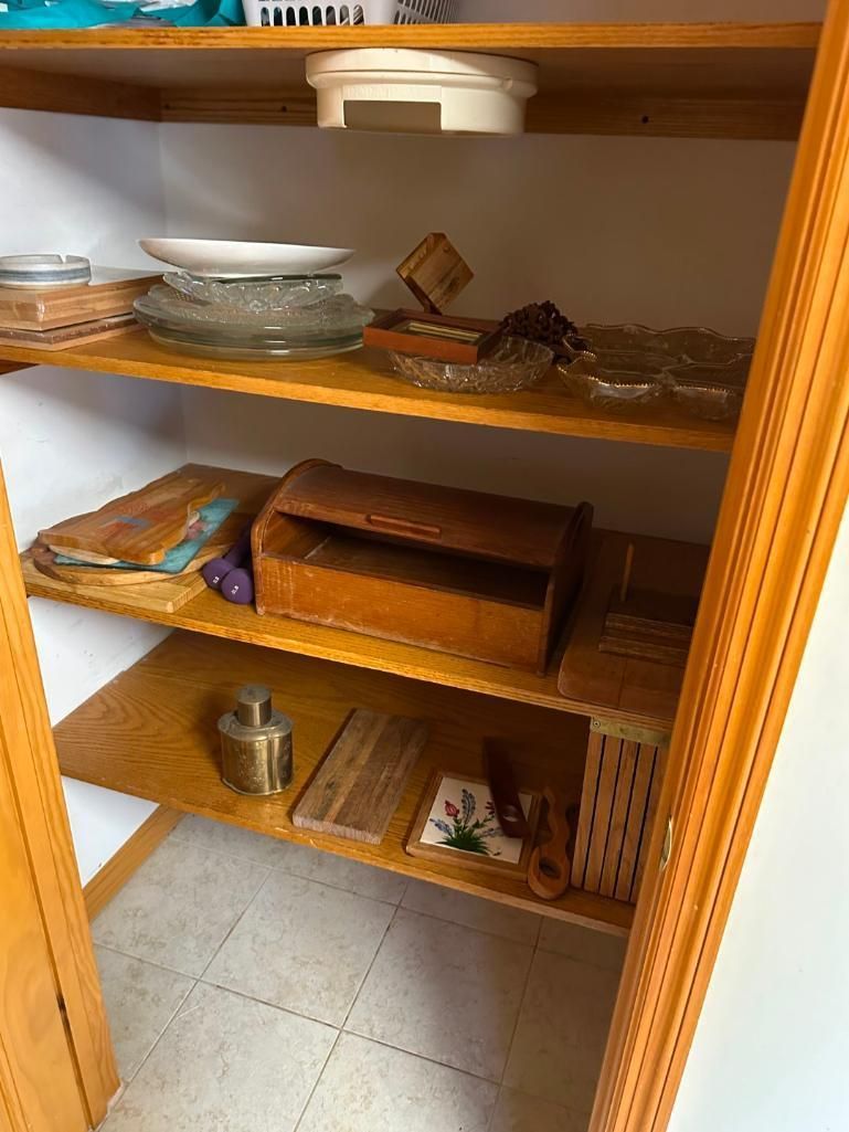 Wooden shelves filled with dishes, jars, and decorative items.