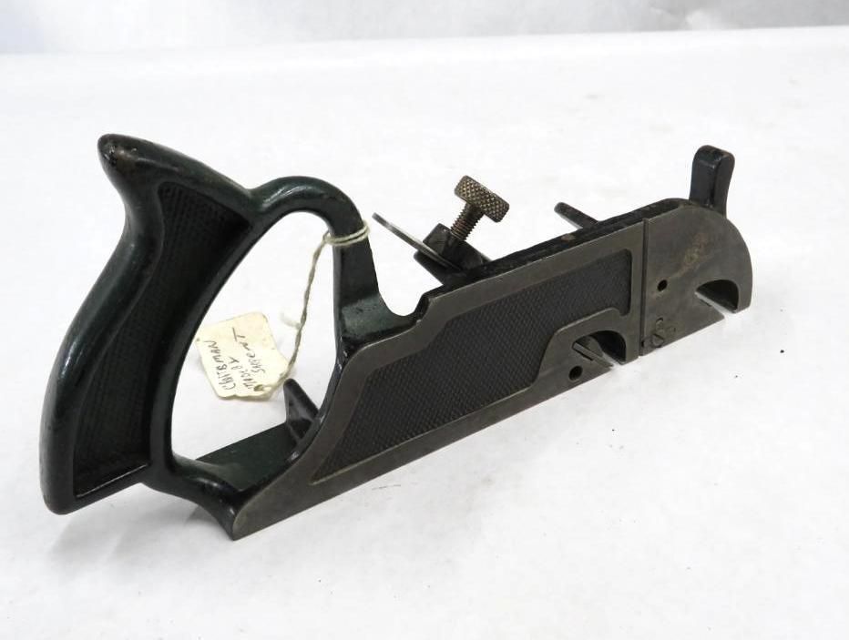 Dark gray metal hand plane with a handle and blade adjustment screw.
