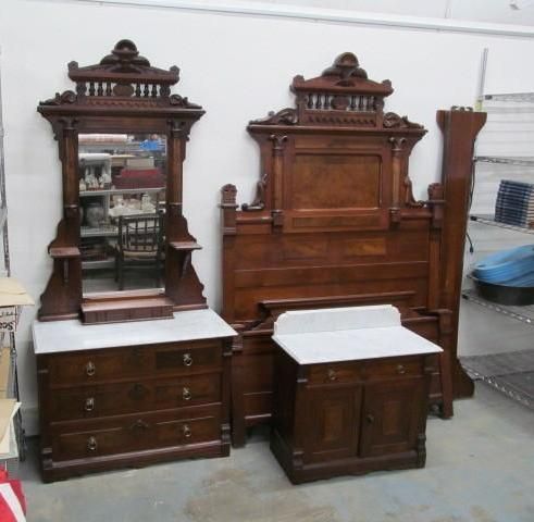 Antique bedroom set: wooden bed frame, dresser with mirror, and nightstand, all with marble tops.
