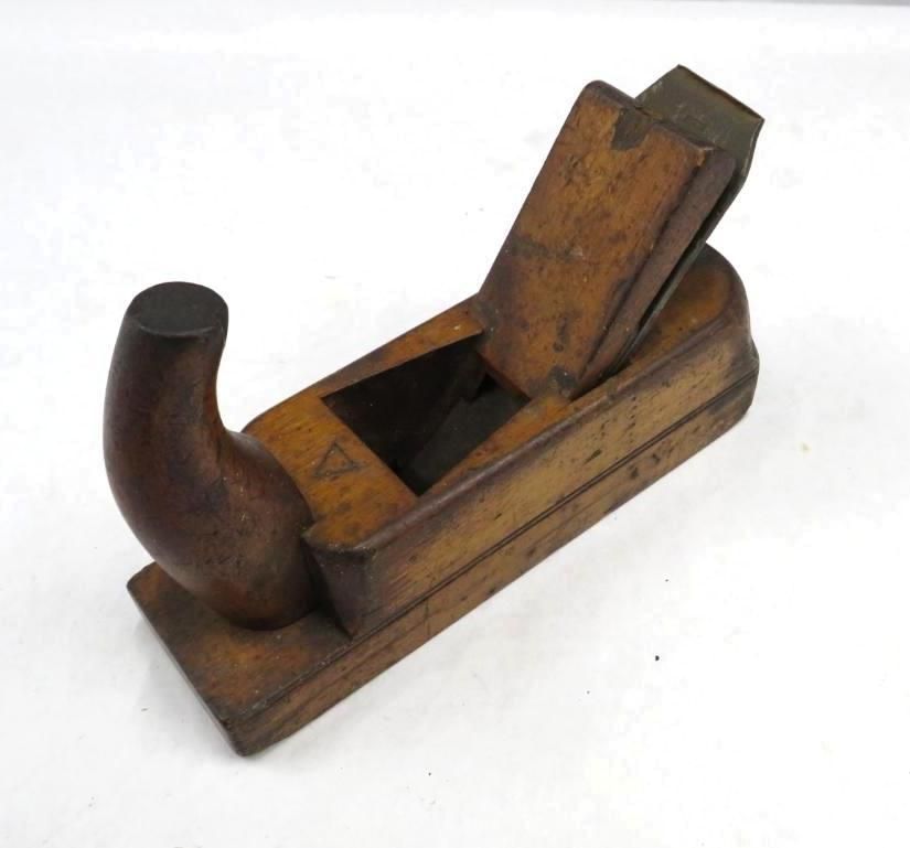 Wooden hand plane with a dark handle, on a white surface.
