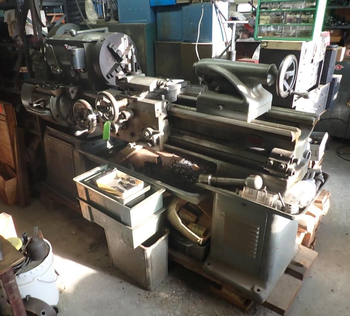 Large gray metal lathe machine in a workshop setting.