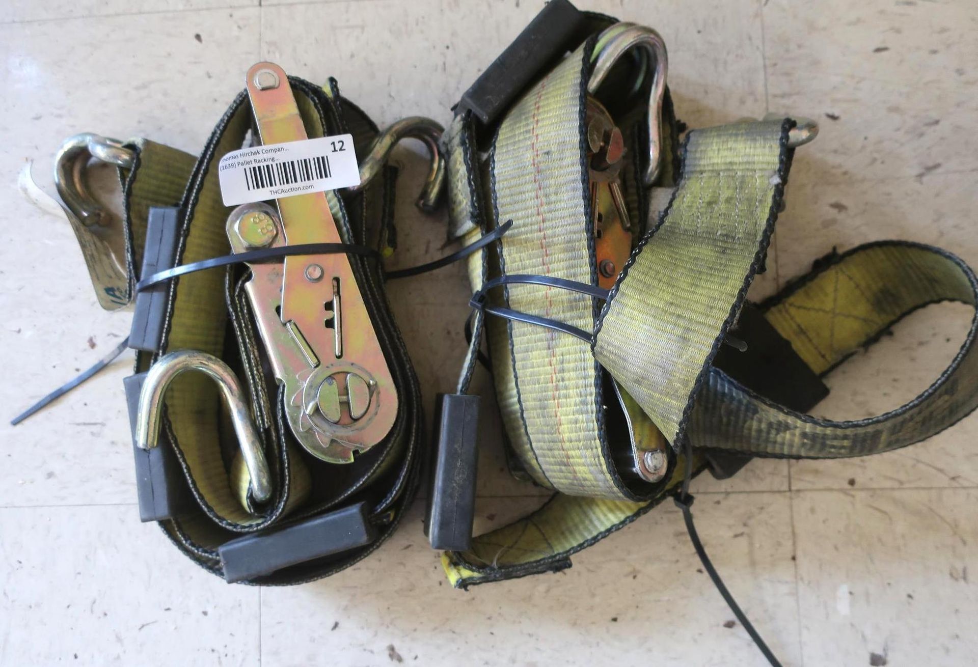 Two yellow ratchet straps with metal hooks, bundled with black zip ties.