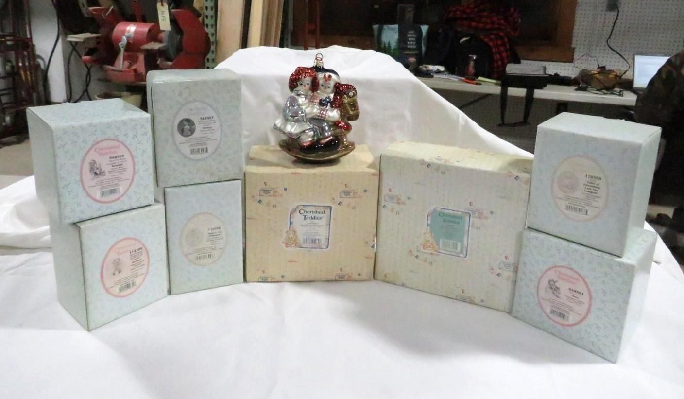 Eight square boxes, light blue and tan, arranged with a decorative statue on a white surface.