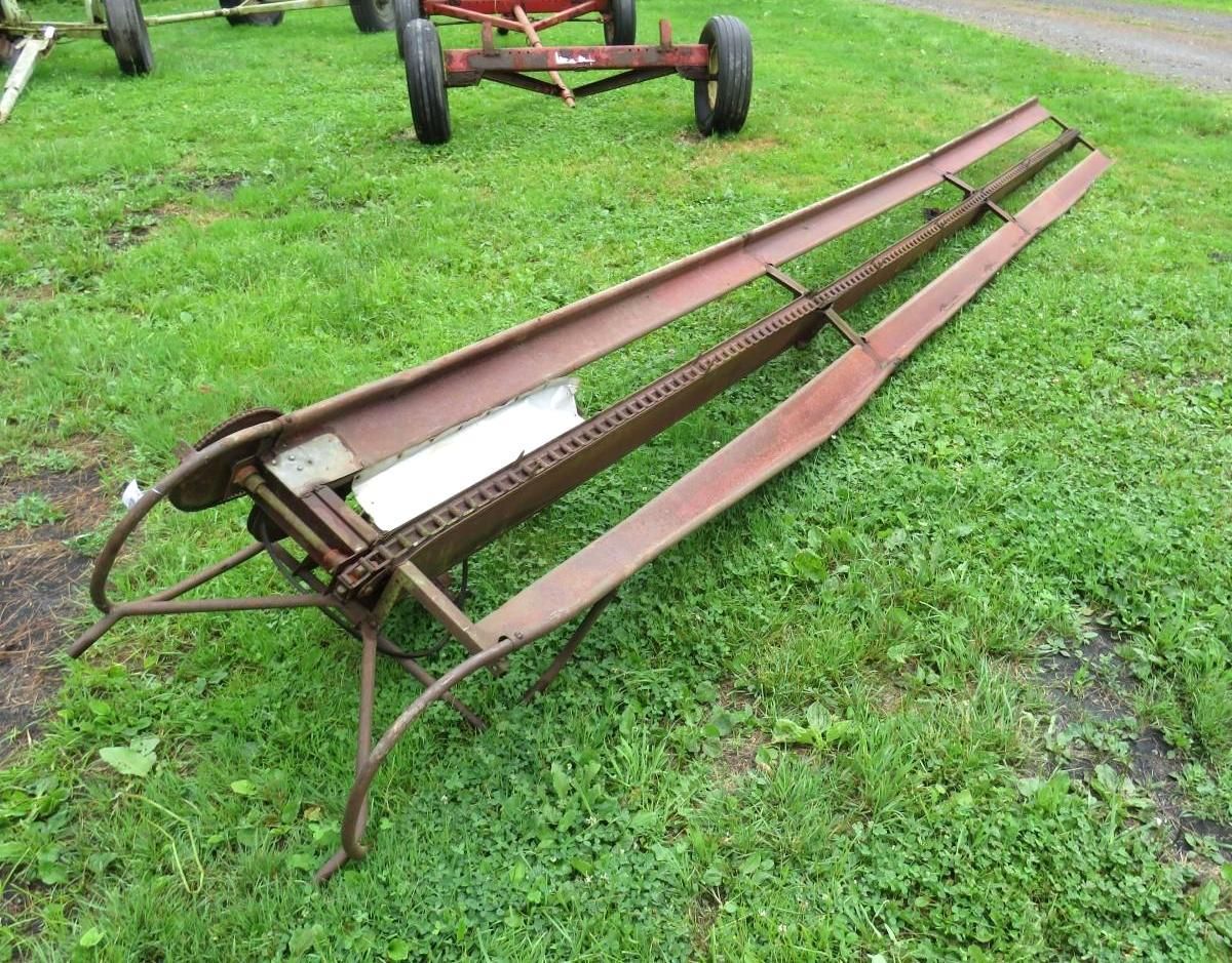 Metal farm equipment on grass.