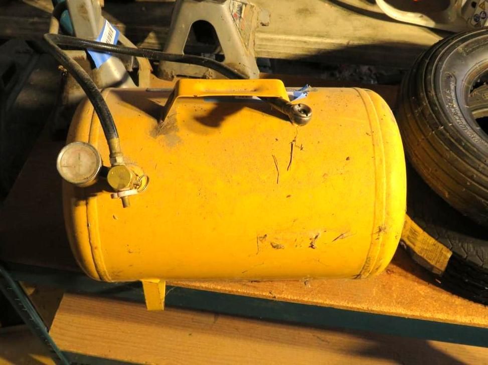 Yellow air tank with gauge and handle.