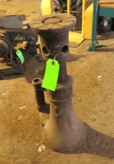 Screw jack with a green tag.