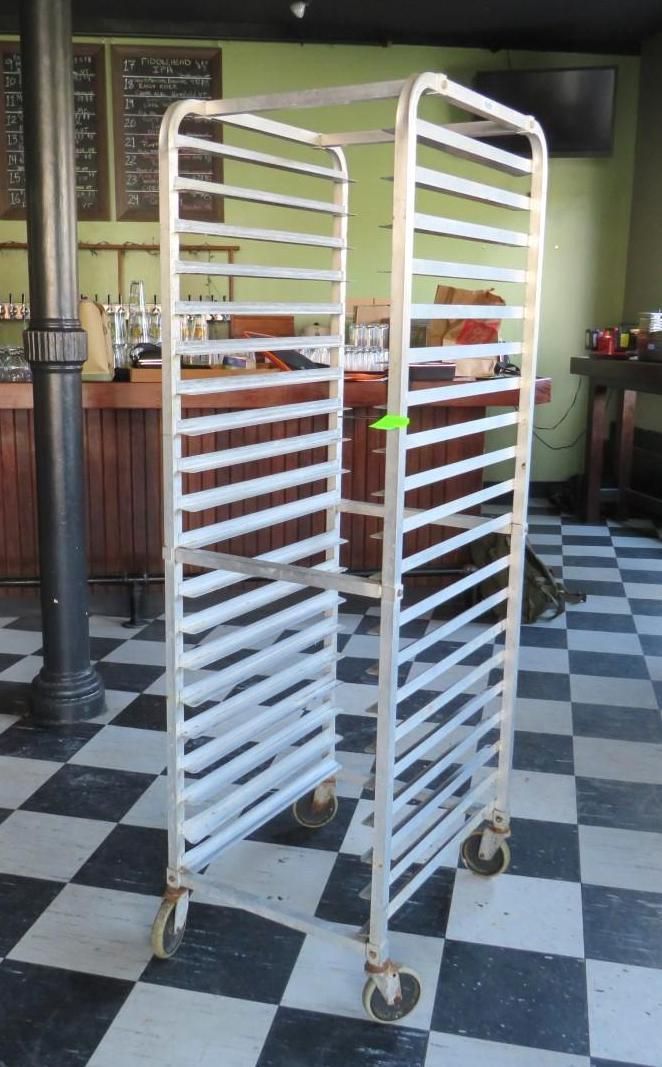 Metal rolling rack with several horizontal bars.