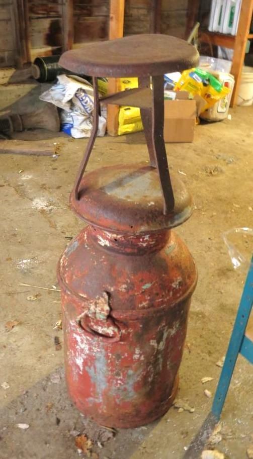 Milk can topped with a stool.