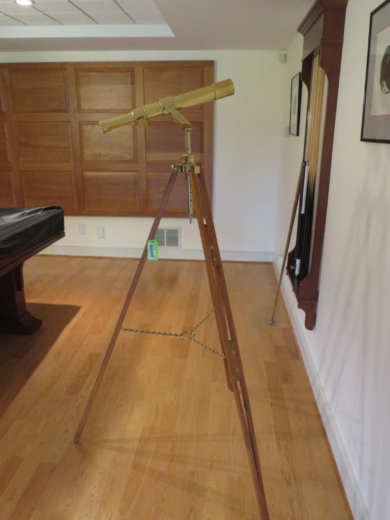 Telescope on a wooden tripod.