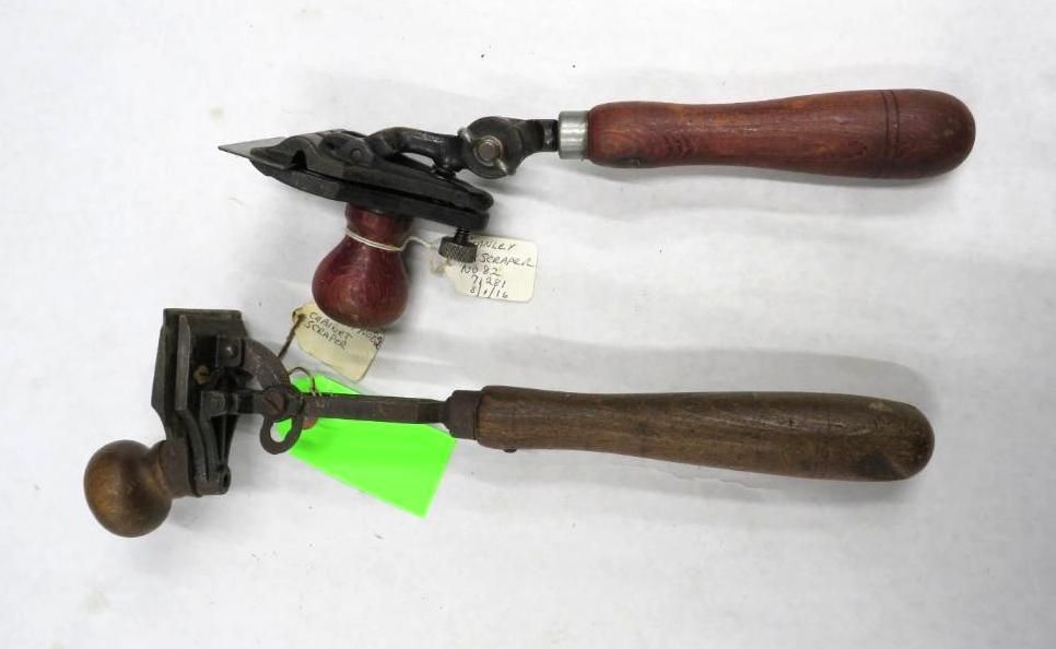 Two antique woodworking tools with wooden handles.