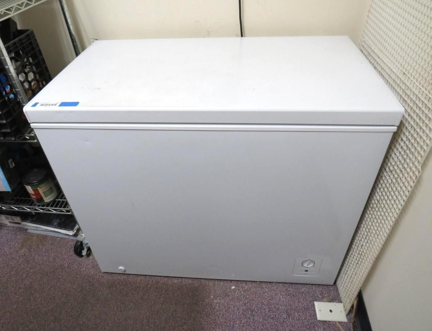 White chest freezer in a corner.