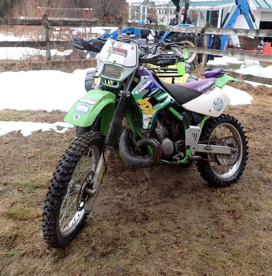 A green and white Kawasaki dirt bike.