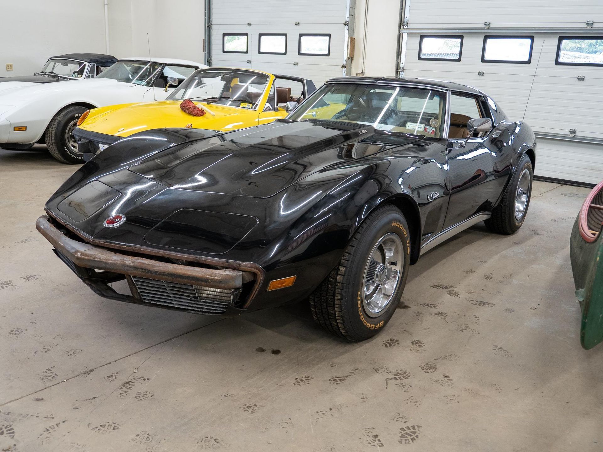 Black Corvette in a garage.