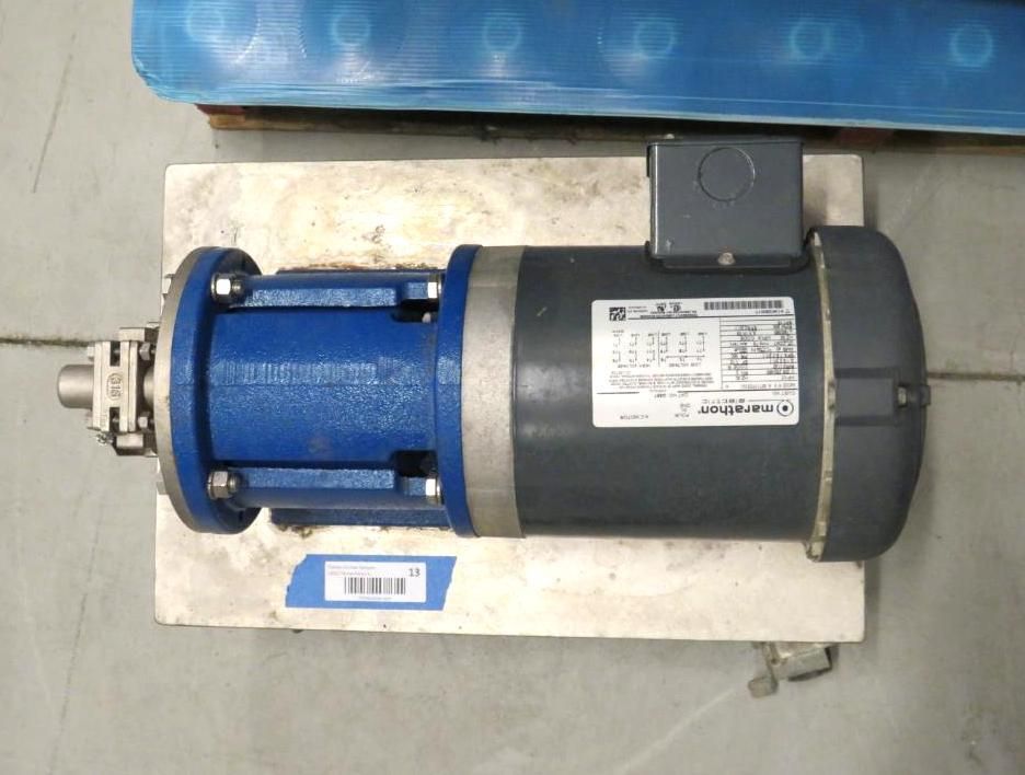 Blue and gray industrial pump and motor on a metal surface.