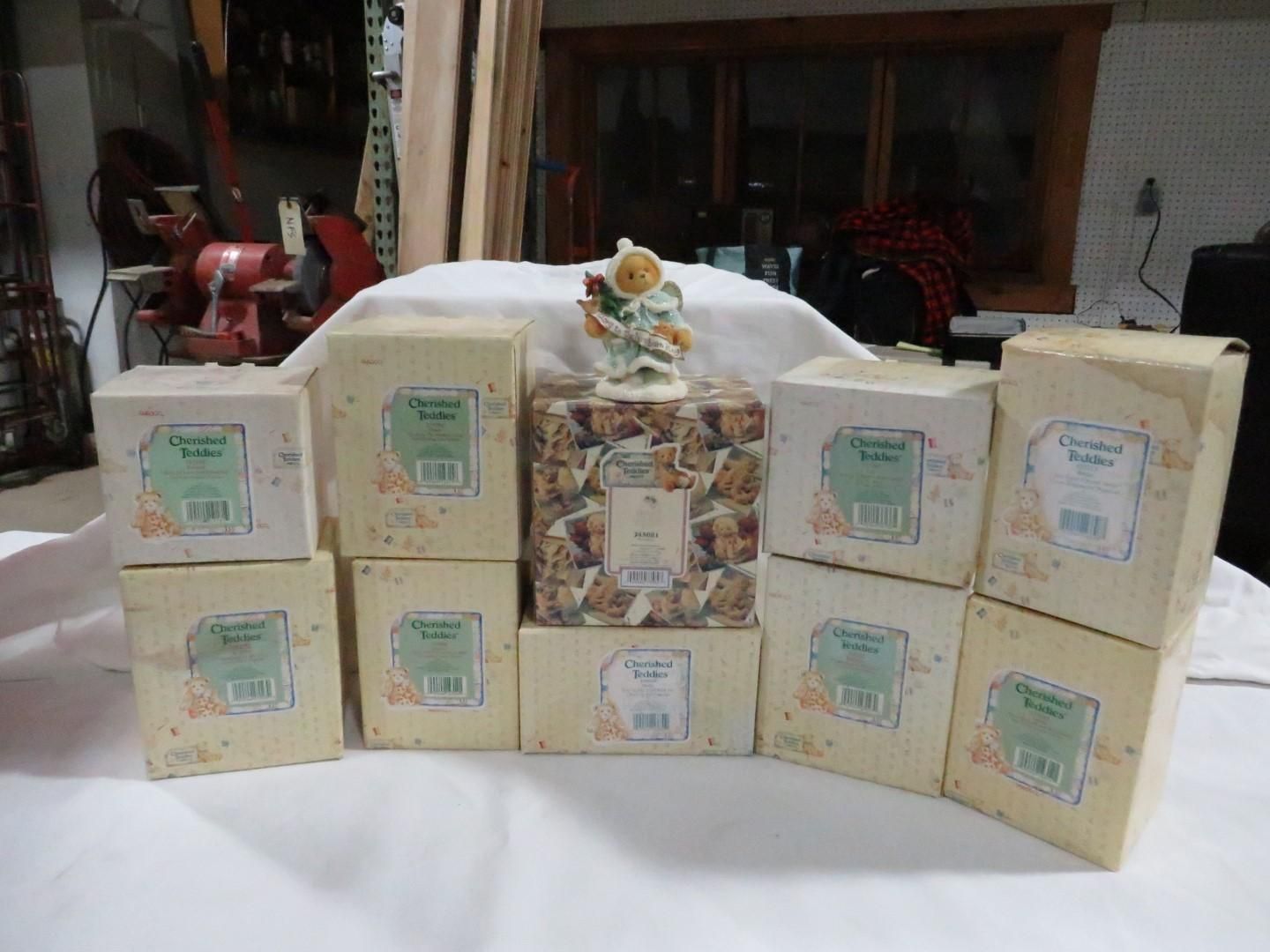 Boxes of various sizes, beige, with floral designs, surrounding a figurine. Interior setting.