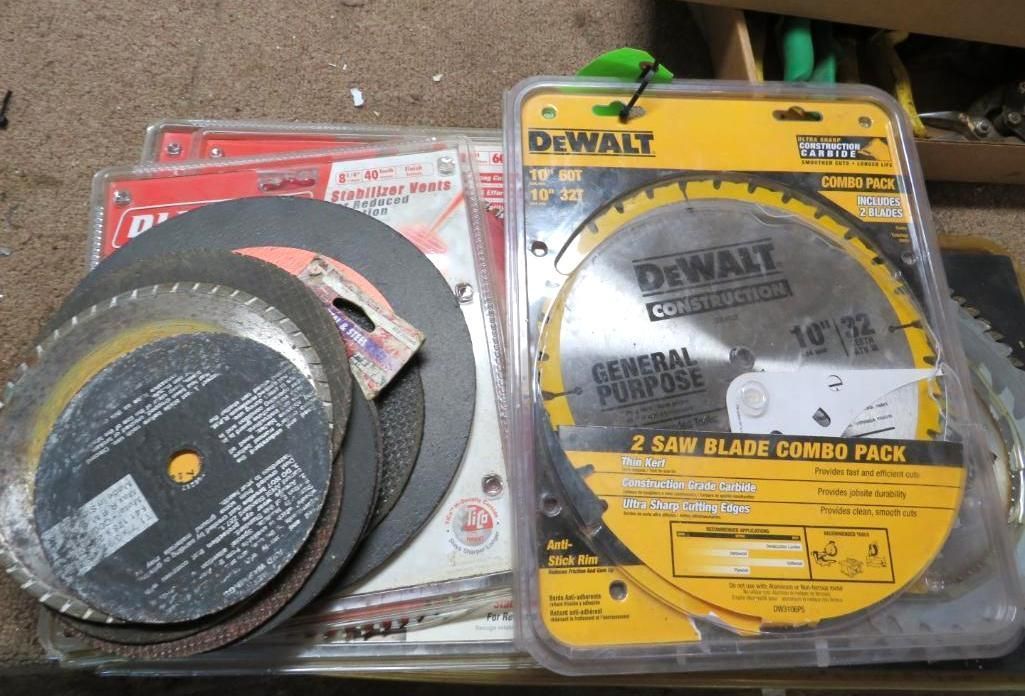 DeWalt saw blades in packaging and loose. Several metal circular blades.