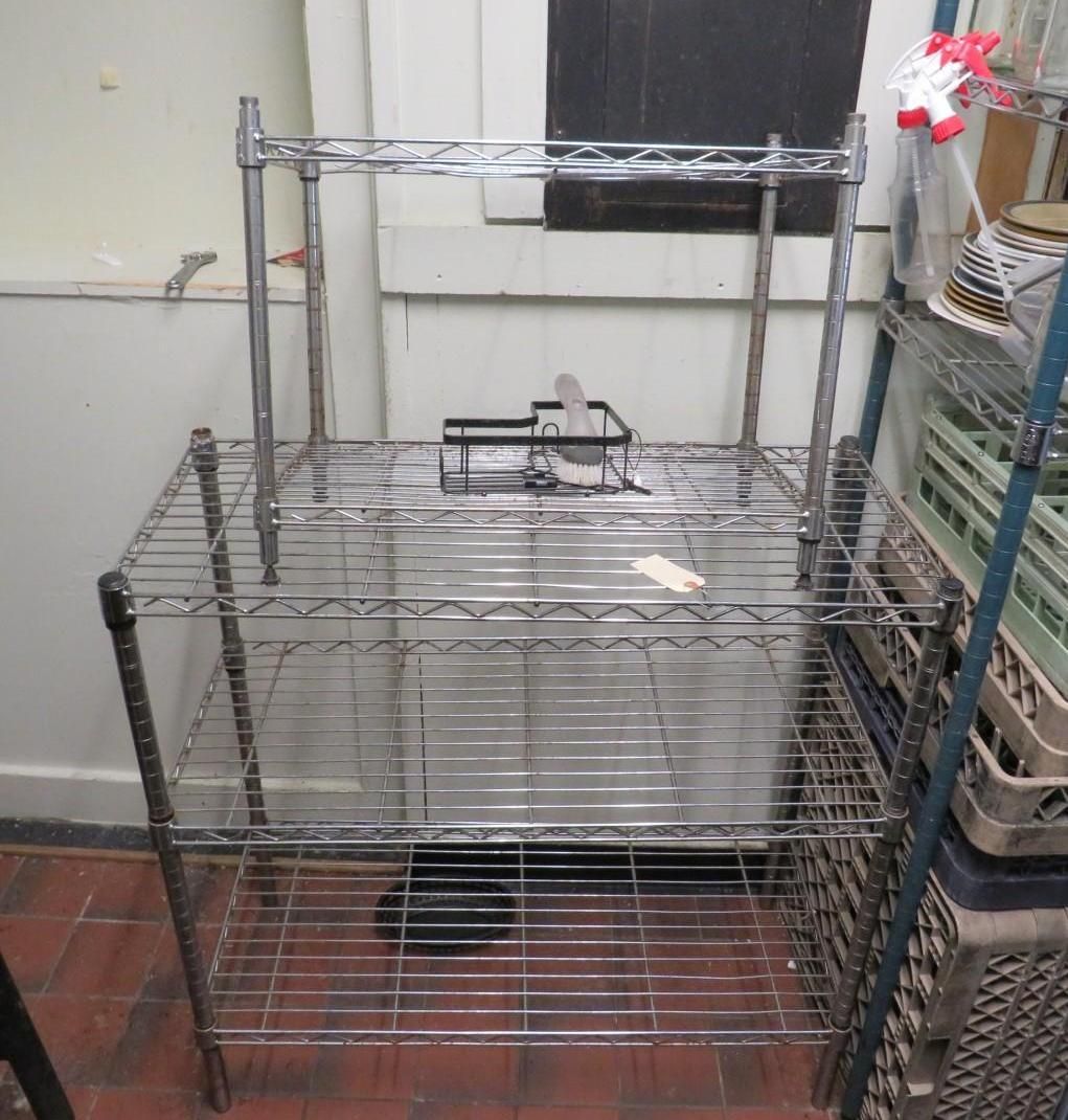 Chrome wire shelving unit with three levels, a top shelf, and a small scale.