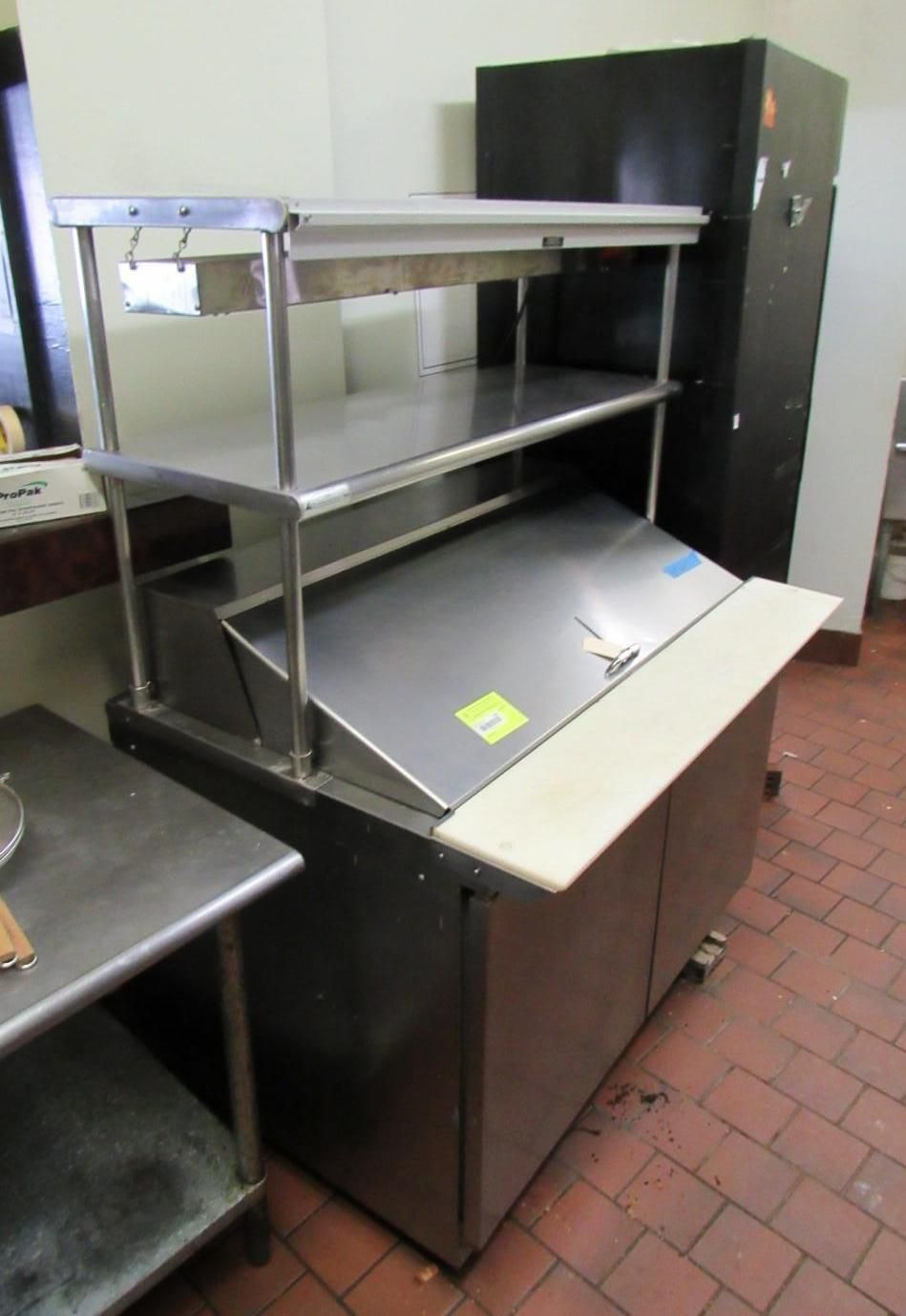Stainless steel kitchen food preparation and storage unit with shelving.