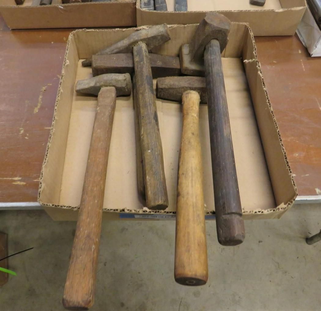 Wooden handled hammers in a cardboard box.