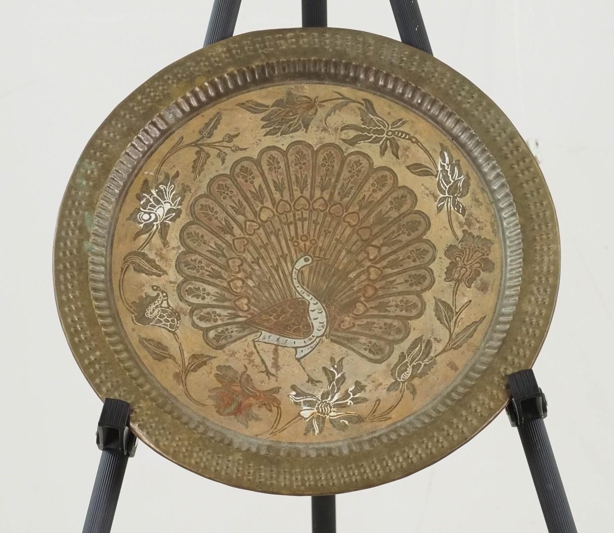 Brass tray with peacock design and floral border.