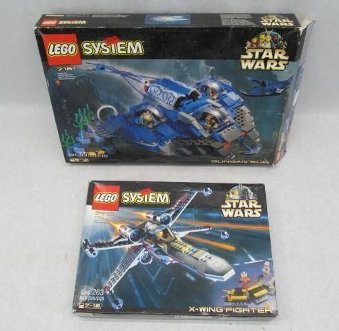 Two LEGO Star Wars boxes: blue B-wing fighter and X-wing fighter.