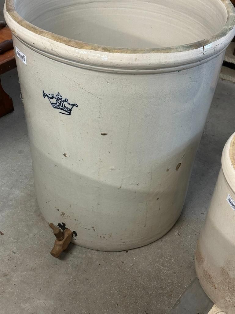 Large, off-white stoneware crock with blue floral design and spigot, likely for storage or fermentation.