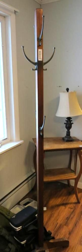 Dark wooden coat rack with hooks.