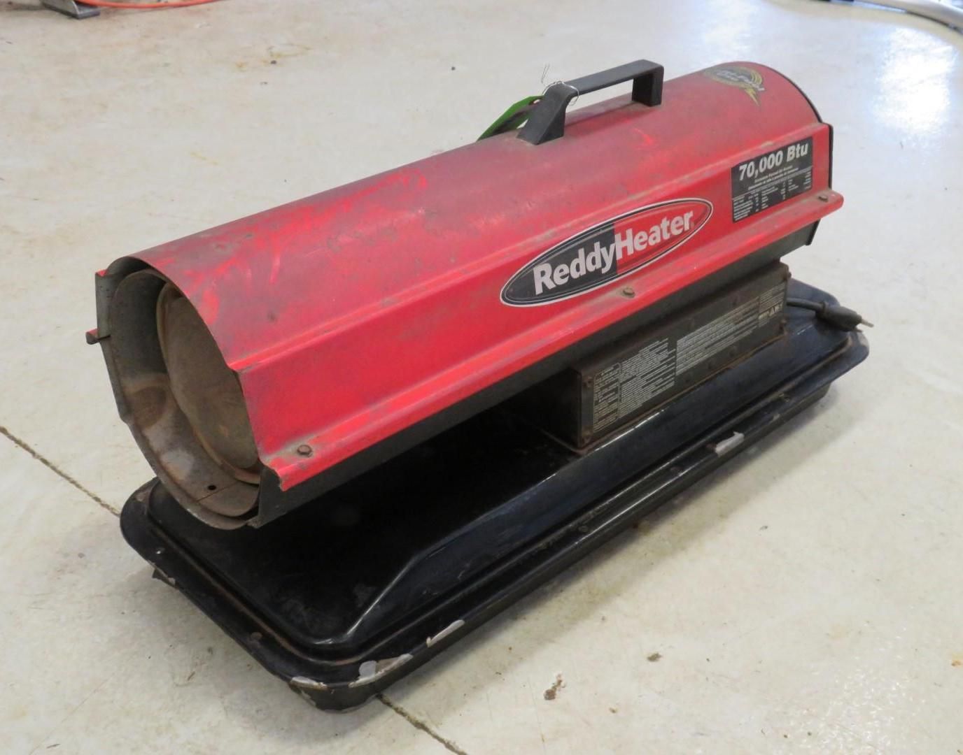 Red Reddy Heater, red and black, on a light floor.