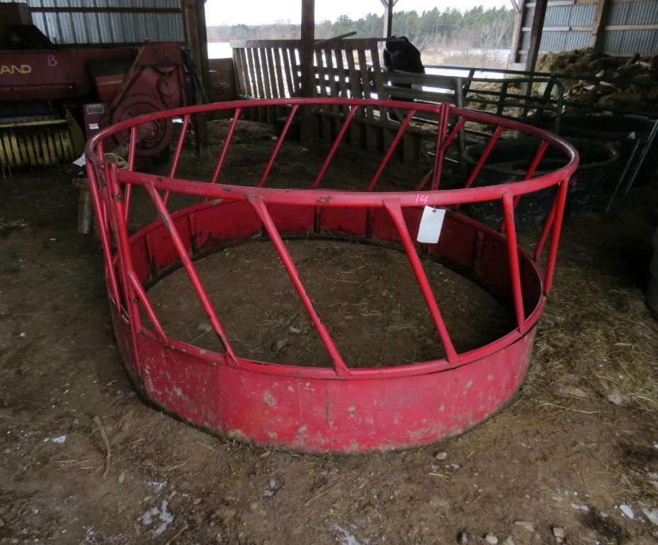 Red, circular livestock feeder.