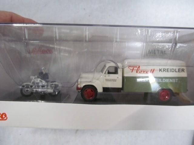 Toy truck with motorcycle, white and green, Kreidler service, red wheels.