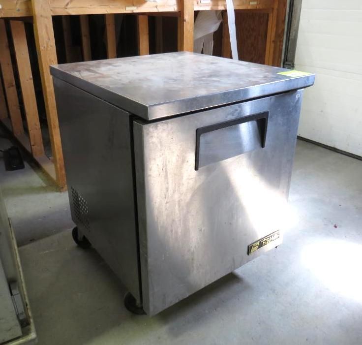 Stainless steel commercial undercounter refrigerator on wheels.