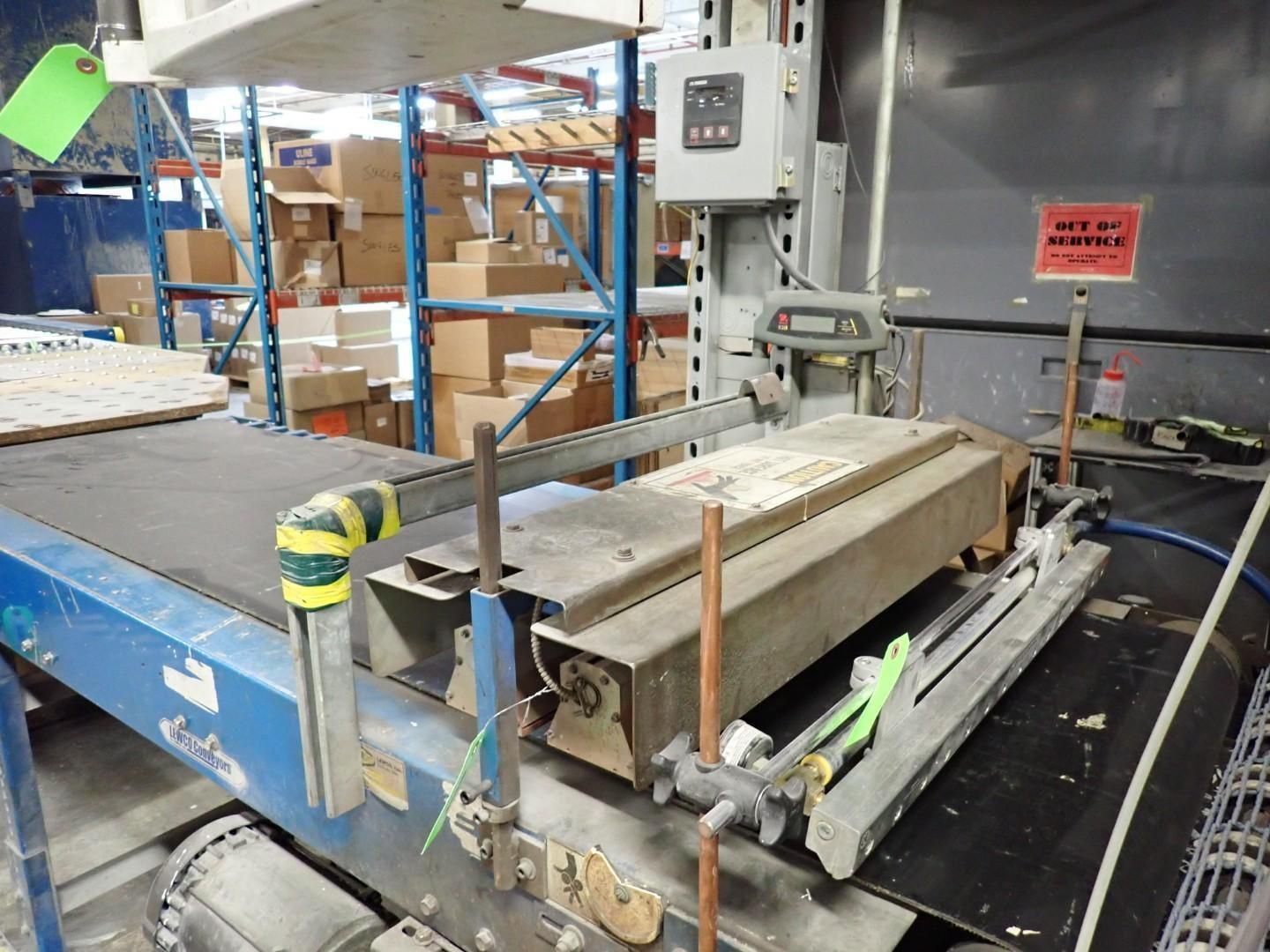 Conveyor belt system with control panel in a warehouse.