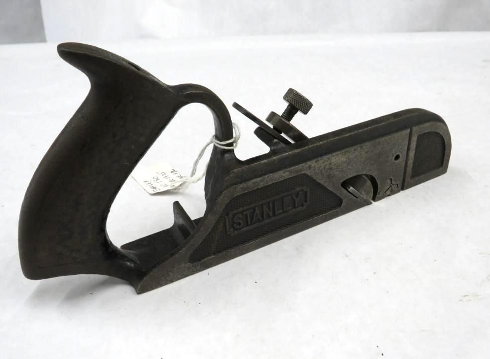 Black Stanley block plane tool on a white surface.
