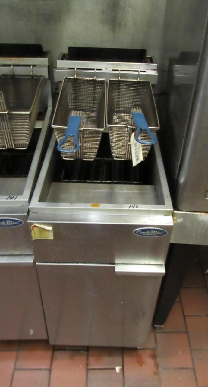 Stainless steel commercial deep fryer with two wire baskets.