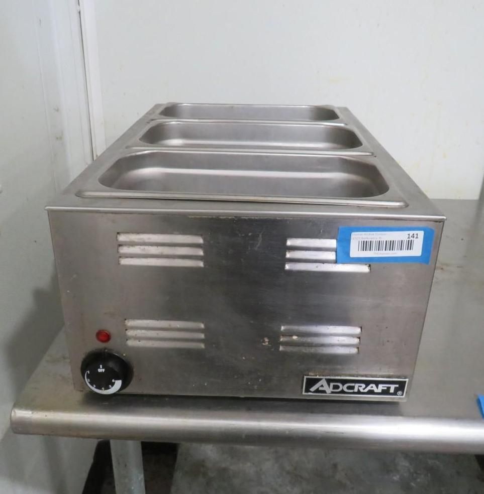 Stainless steel countertop food warmer with three wells, temperature dial, and vent slots.