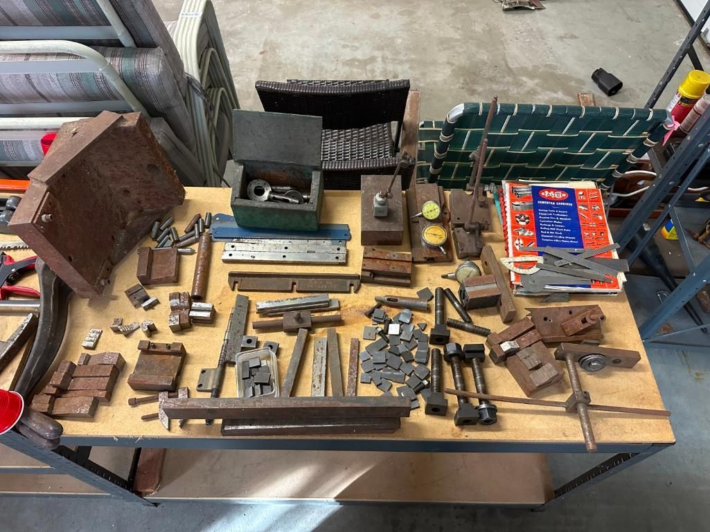 Workbench covered in various metal machine shop tools.