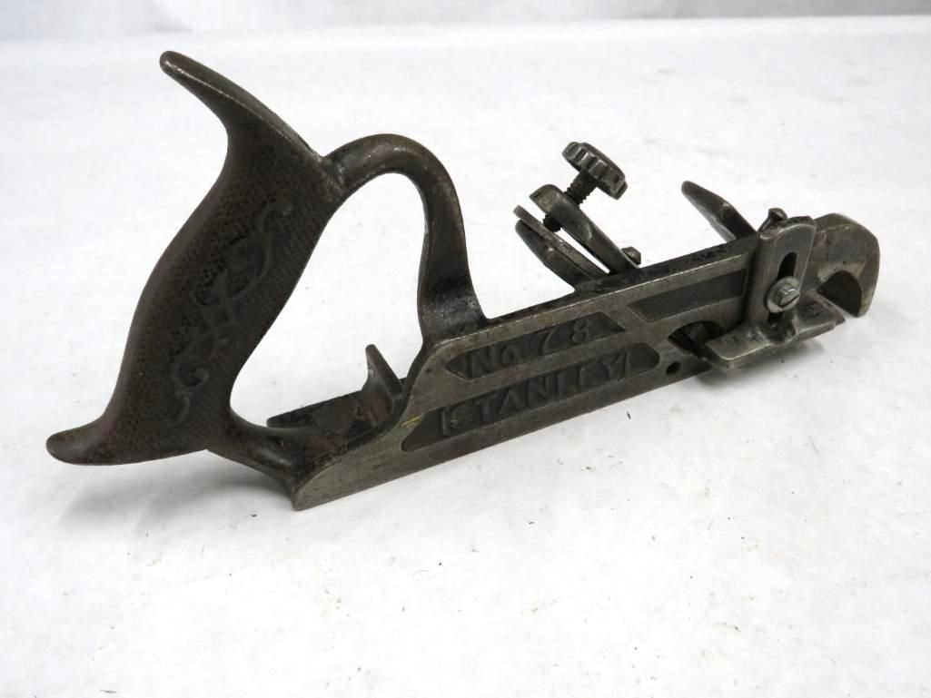 Antique Stanley plow plane, cast iron, with adjustable blade and wooden handle.