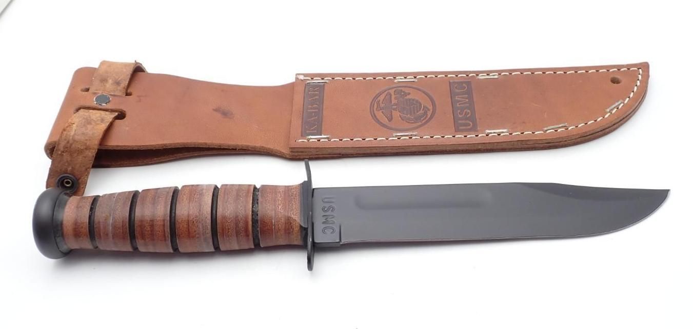 Fixed-blade hunting knife with leather sheath, brown handle, and gray steel blade on a white background