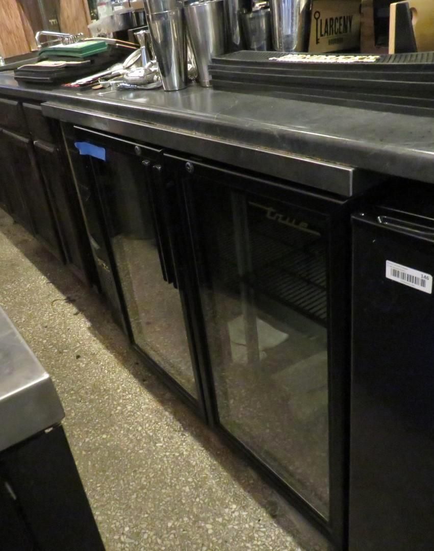 Bar with glass-front coolers behind the counter.