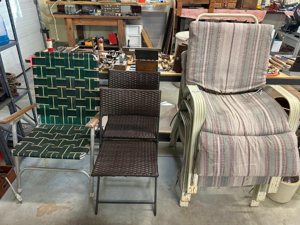 Three different types of chairs: green woven, brown wicker, and stacked beige with cushions in a workshop.