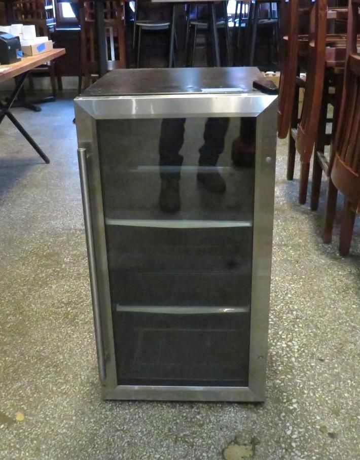 Stainless steel mini-refrigerator with glass door and three shelves.