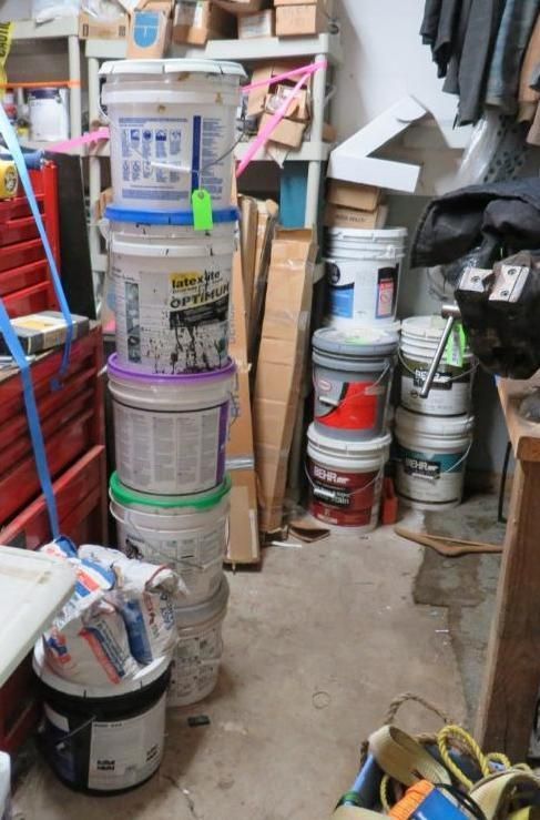Stack of paint buckets and supplies.