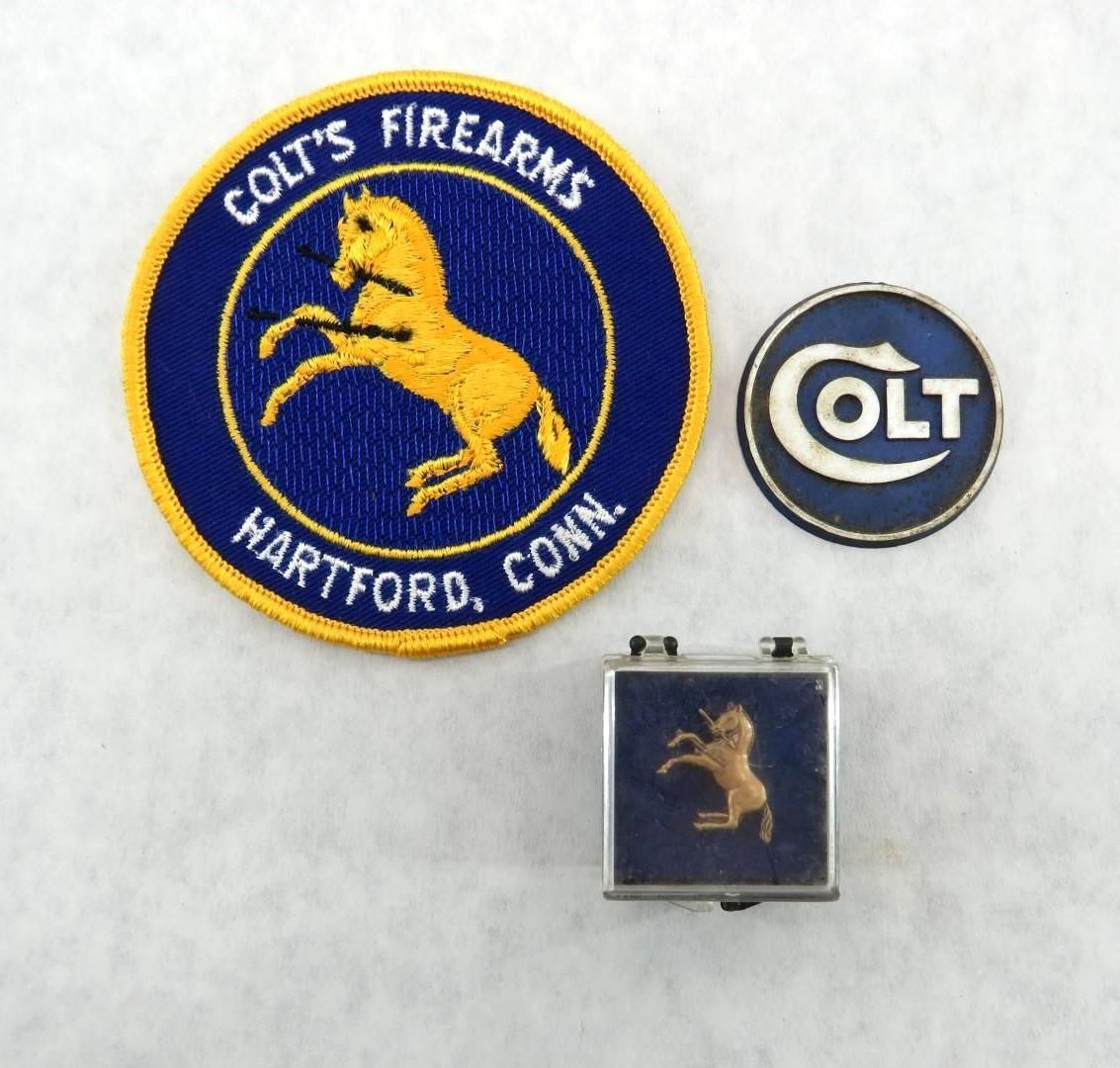 Colt Firearms logos: circular patch with prancing horse, round pin, and pendant, all with blue and gold colors.