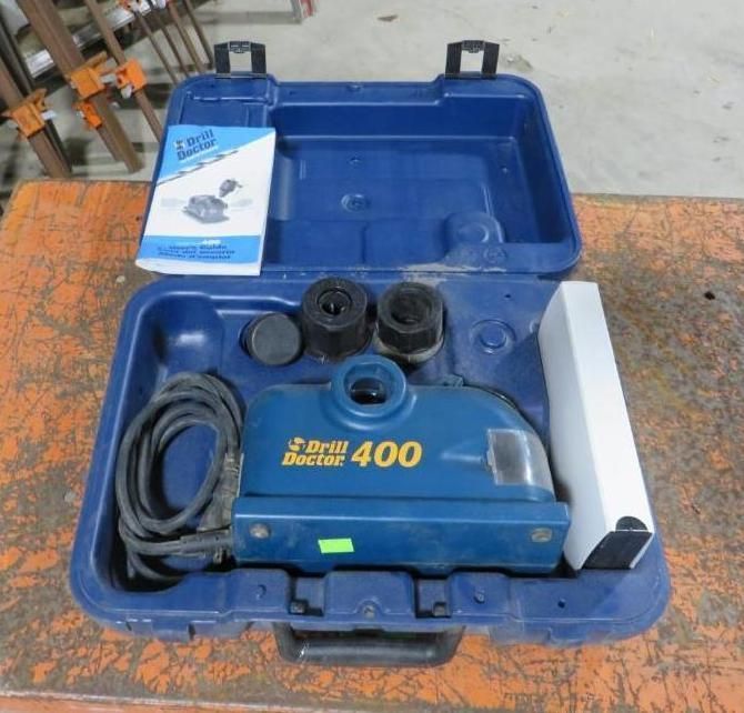 Blue Drill Doctor 400 tool in its case, with accessories and manual.