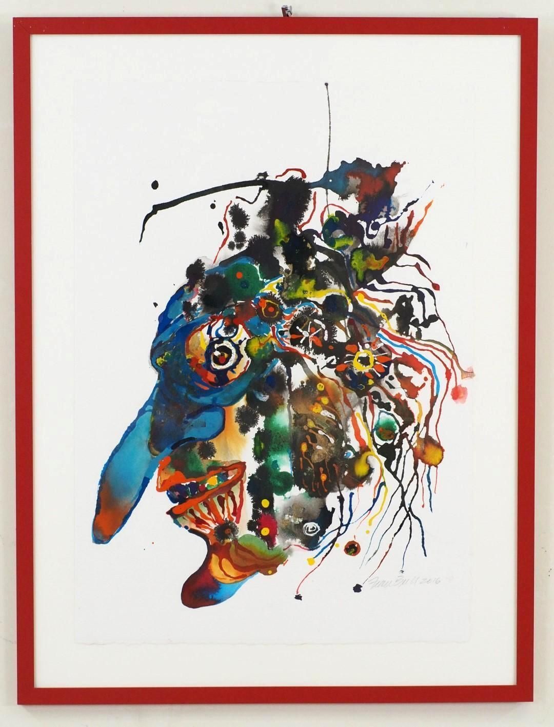 Abstract watercolor painting in red frame featuring colorful splatters resembling a face.