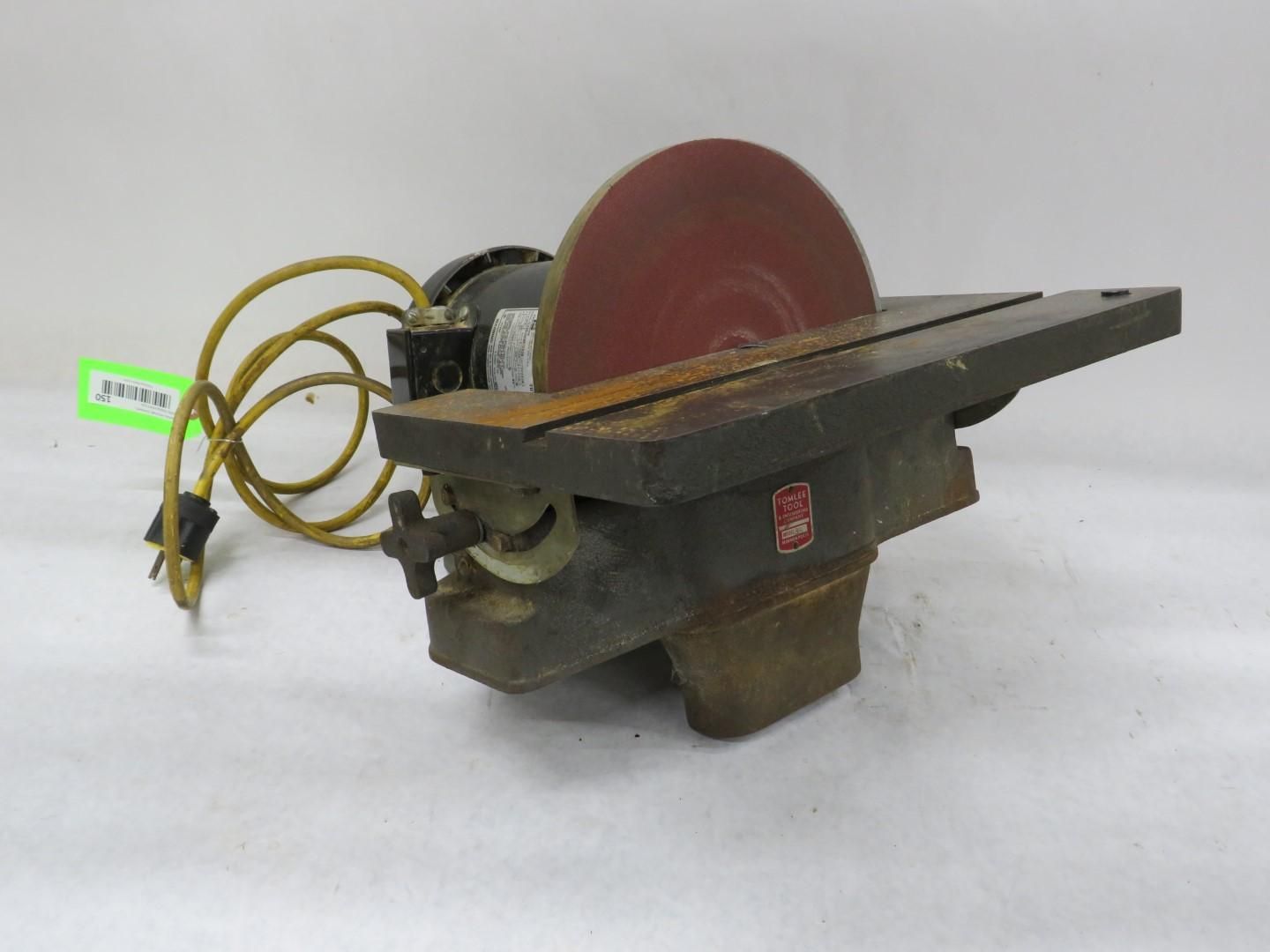 A Delta disc sander with a red abrasive disc, black motor, and yellow power cord.