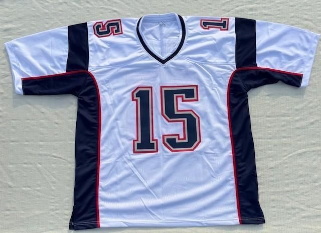 White football jersey with navy and red accents, number